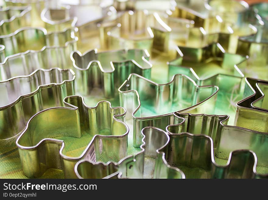 Close up of metal animal shaped cookie cutters on kitchen counter.