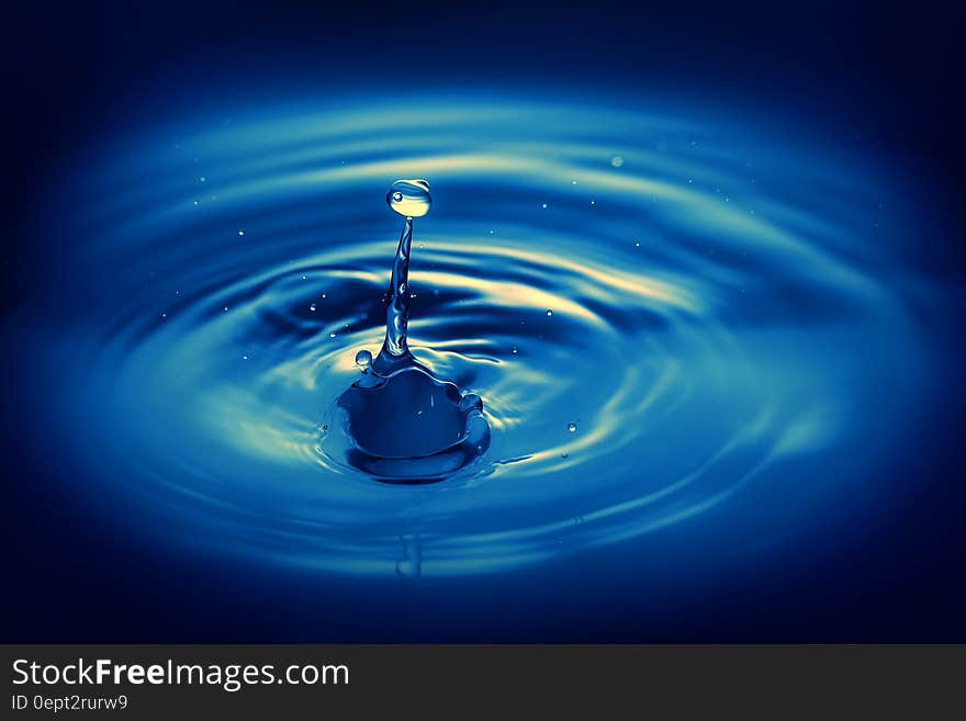 Ripple in blue waters of drop splashing. Ripple in blue waters of drop splashing.