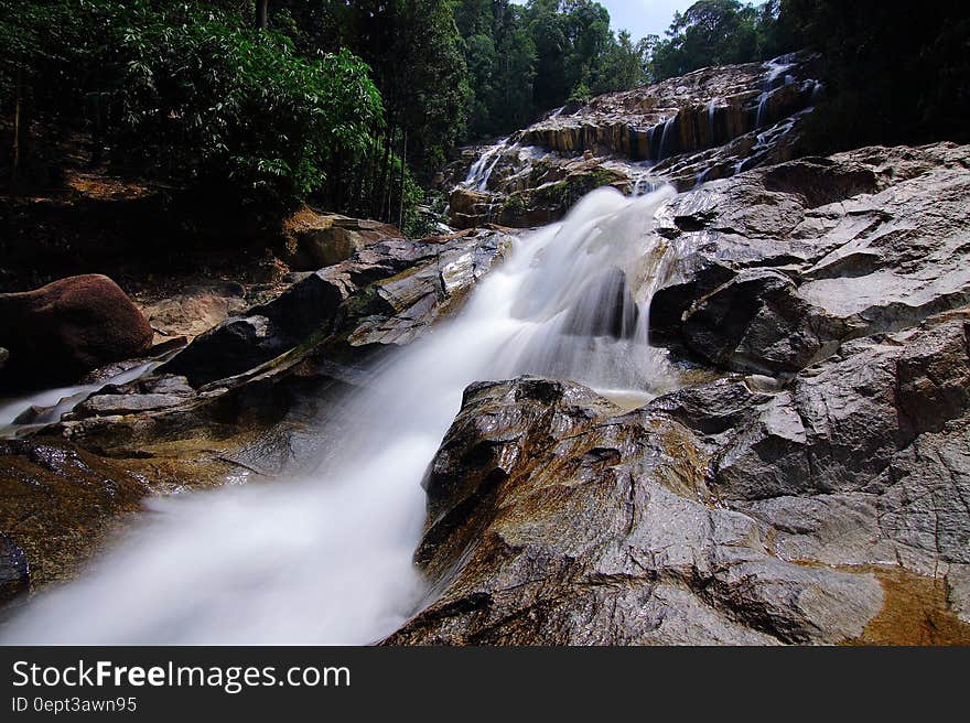 Waterfalls on Rocks Surrounded by Trees