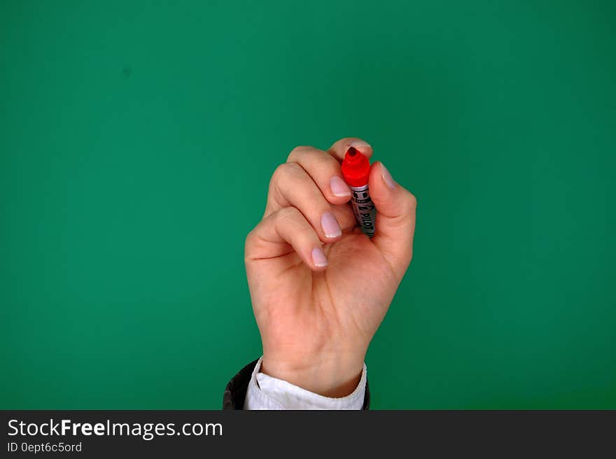 Person Holding Red Marker