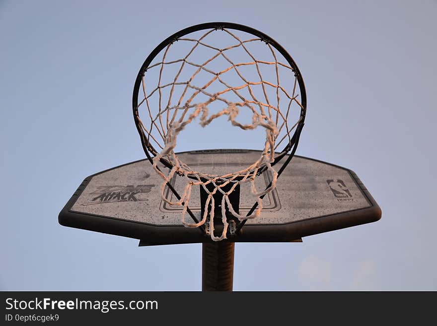 A basketball backboard with a basket attached to it. A basketball backboard with a basket attached to it.