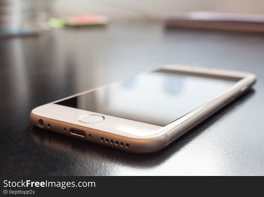 A close up shot of an Apple iPhone 6 smartphone on a table.