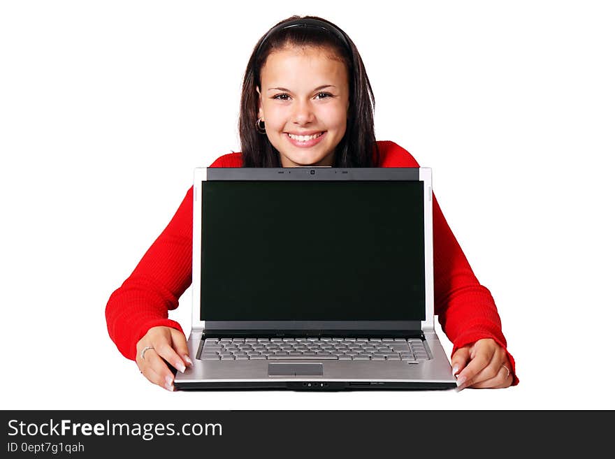 A young woman holding a laptop computer. A young woman holding a laptop computer.