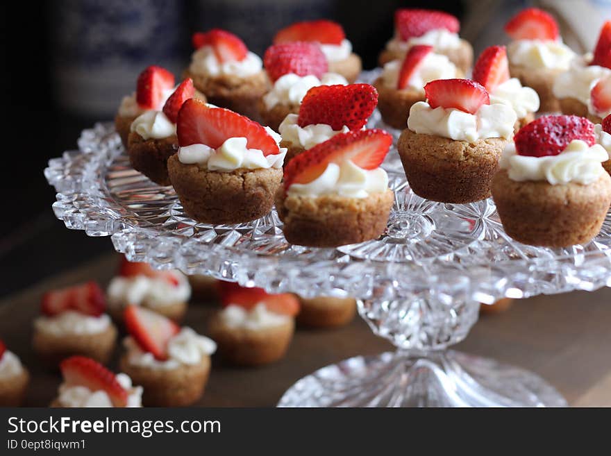 Cupcake With Strawberry Toppings on Clear Glass Cup Cake Rack