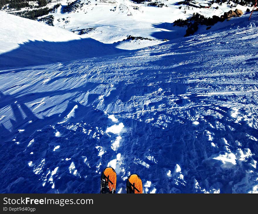 A downhill skier on the slope with the point of view of the skier. A downhill skier on the slope with the point of view of the skier.