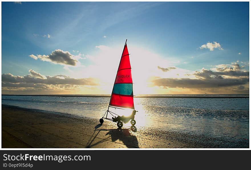 Golden dawn with three wheel wind bike (tricycle) on beach with tide going out. Golden dawn with three wheel wind bike (tricycle) on beach with tide going out.