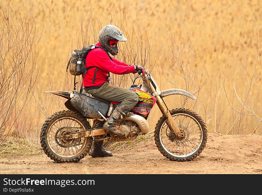 Man in Red Sweater Driving Dirt Bike