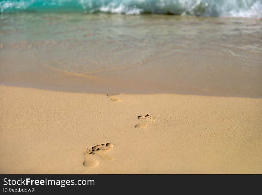 Child's footprints in the sand on a beach. Child's footprints in the sand on a beach.