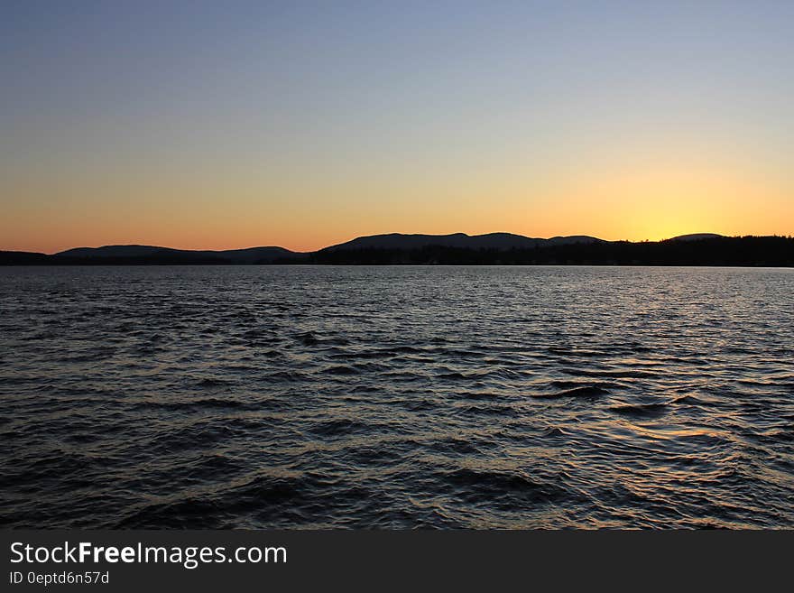 A tranquil lake during sunset.