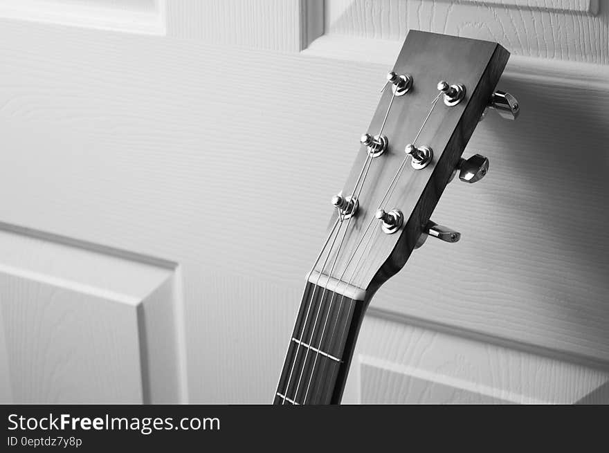 A guitar headstock and bridge close up.