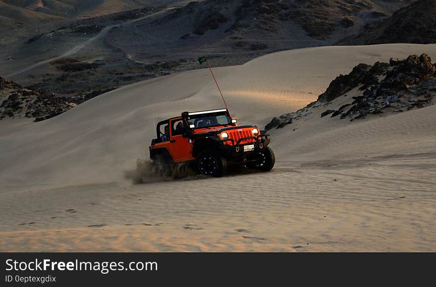 Red Jeep Wrangler on White Covered Field