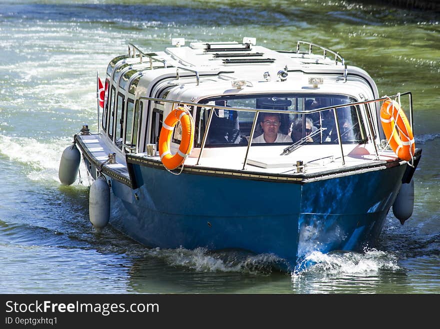 A motorboat moving along a water surface. A motorboat moving along a water surface.