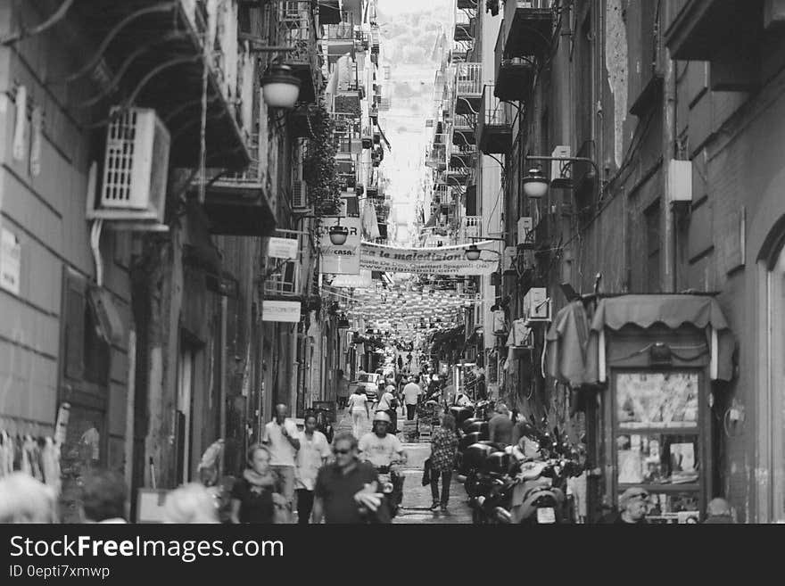 Narrow bustling Italian street with lots of tourists and above on both sides apartment houses with balconies. Narrow bustling Italian street with lots of tourists and above on both sides apartment houses with balconies.