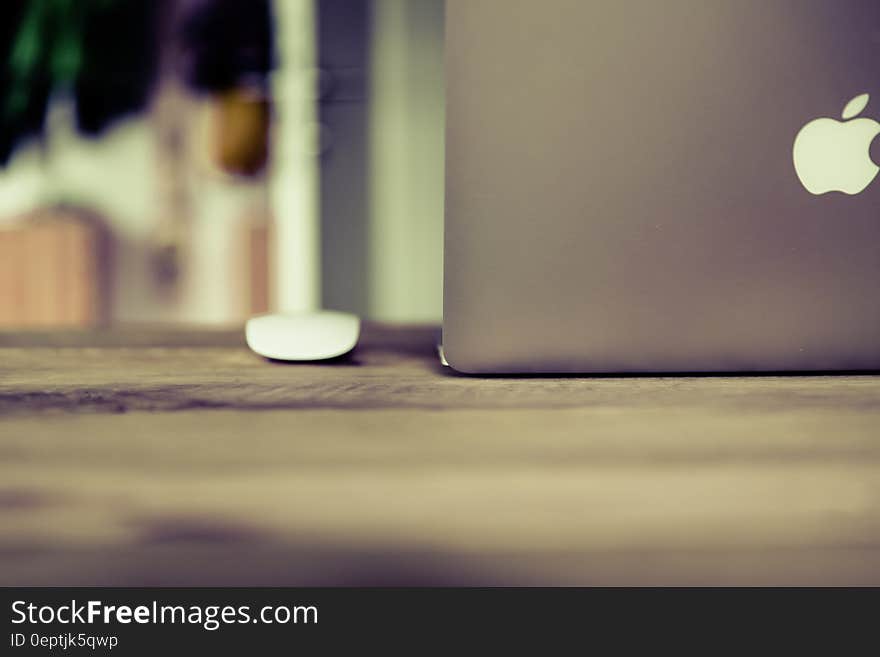 Silver Macbook on Brown Wooden Surface