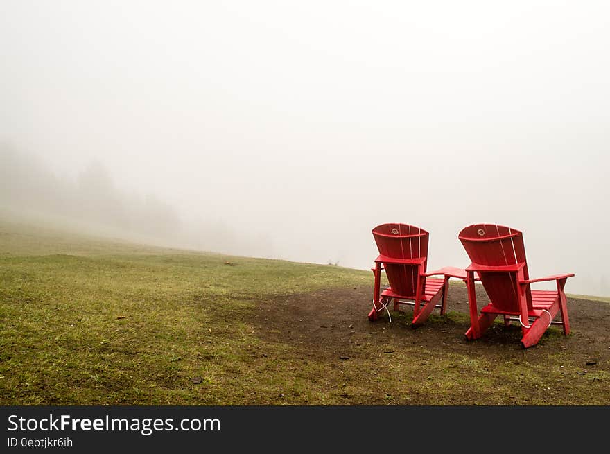 Brown Wooden Beach Lounge Chair on Brown and Green Grass Field