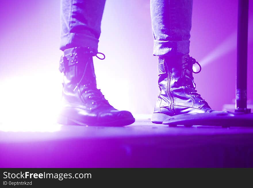 Person Wearing Lace Up Boots Standing on Stage