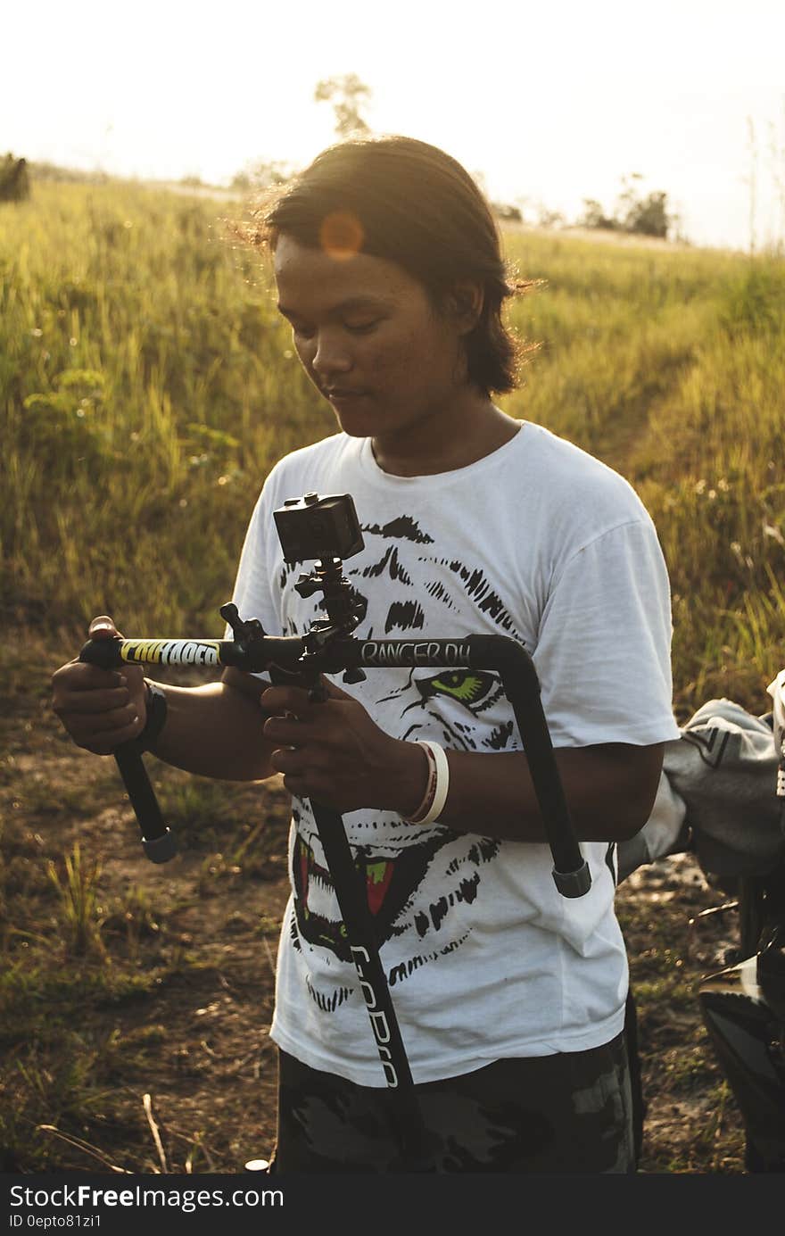 Man With White Black Shirt in Field