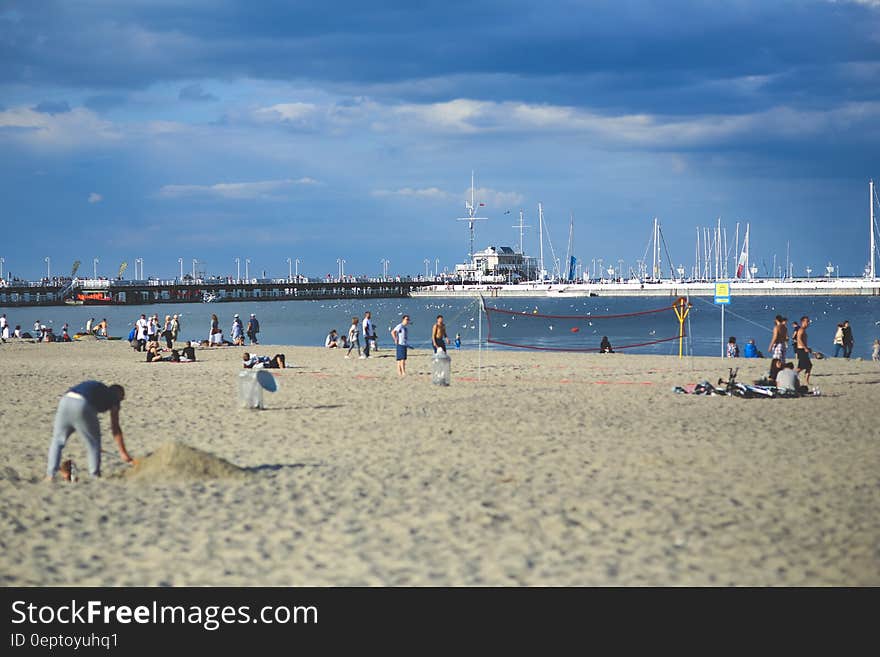 People on the beach. Pier & marina