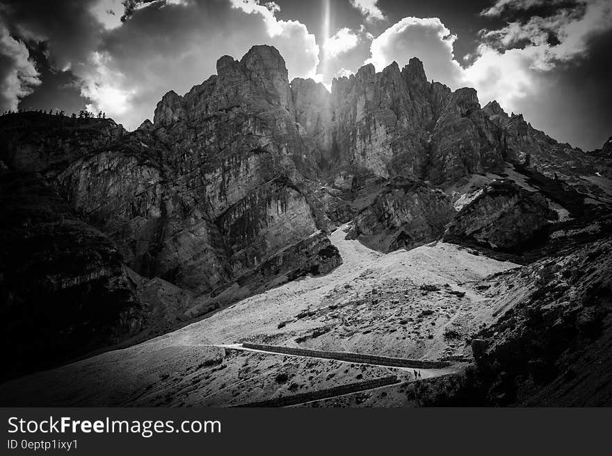 Greyscale Photography of Mountain Under Clouds