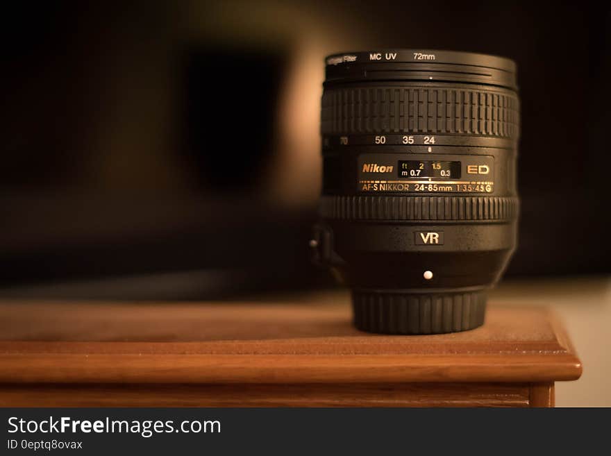 A DSLR camera lens on a table.