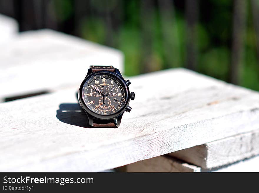 A men's watch on wooden surface. A men's watch on wooden surface.