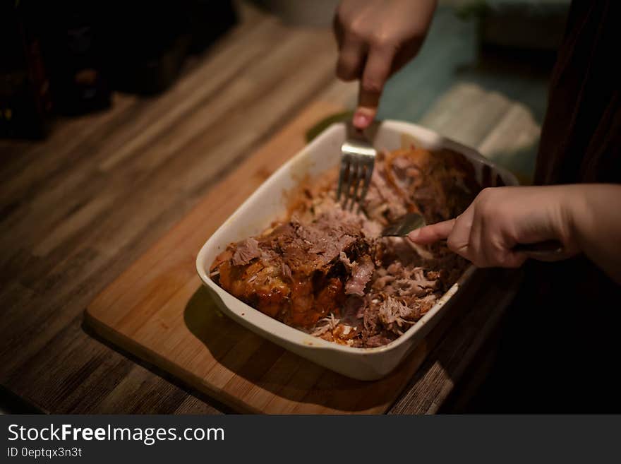 Person Mixing Cook Meat on White Food Container