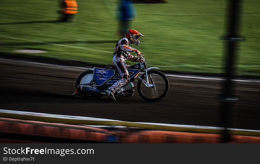 Motocross competitor on dirt track during competition. Motocross competitor on dirt track during competition.