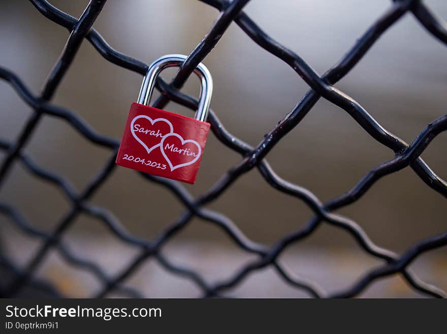 Red and Stainless Steel 2 Hearts Padlock on Black Cyclone Fence during Daytime