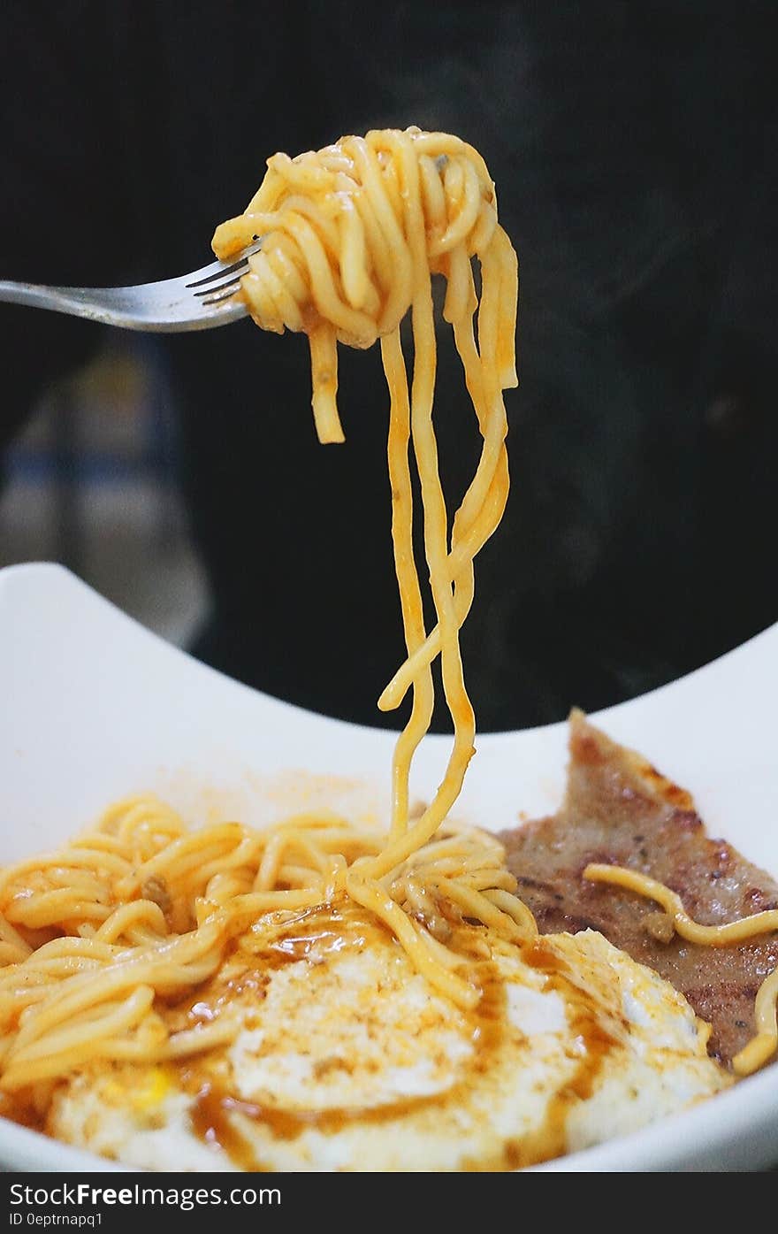 Gray Steel Fork With Yellow Pasta