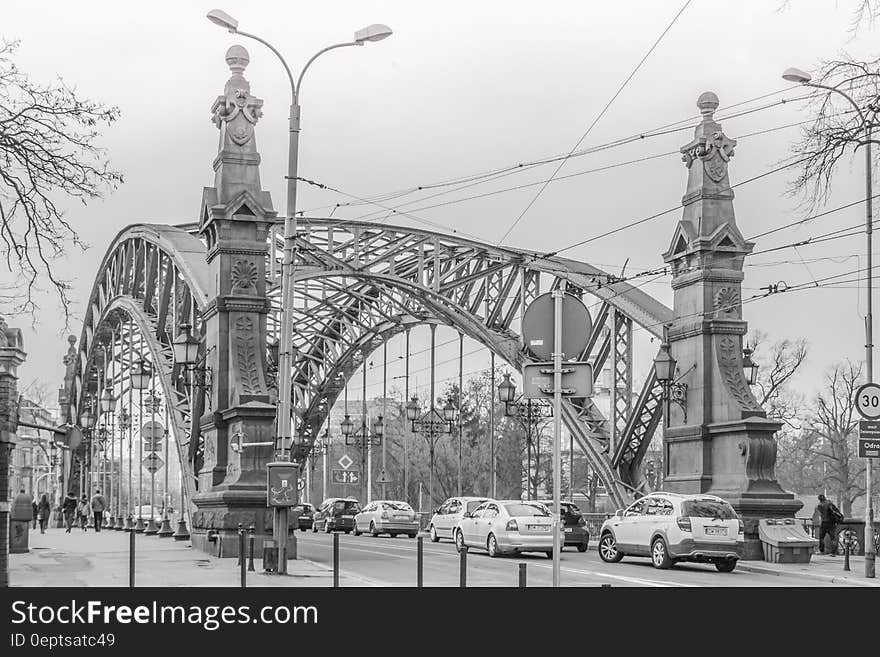 Greyscale Photo of a Bridge With Cars Being Caught in a Traffic during a Snow Weather