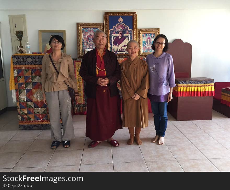 Indoor Asian family portrait inside temple at alter.