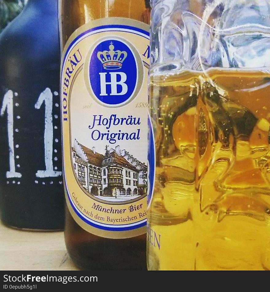 Bottle of Hofbrau Original beer next to glassware.