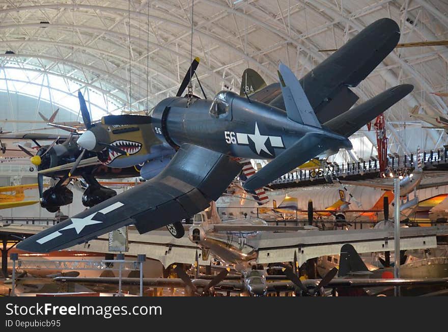 Vintage fighter jets suspended from ceiling of museum hall. Vintage fighter jets suspended from ceiling of museum hall.