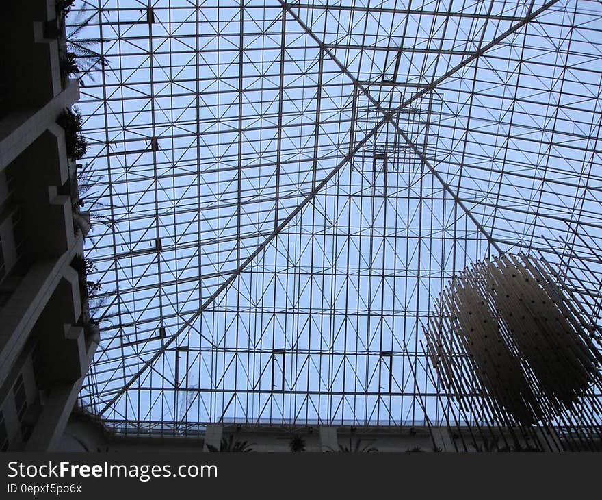 Skylight covering large indoor ceiling with metal grates. Skylight covering large indoor ceiling with metal grates.