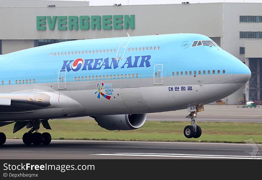 Korean jumbo jet landing on runway at international airport. Korean jumbo jet landing on runway at international airport.