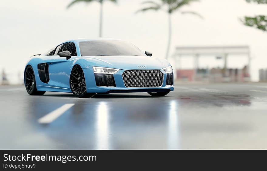 Blue luxury sports car in wet parking lot outside. Blue luxury sports car in wet parking lot outside.