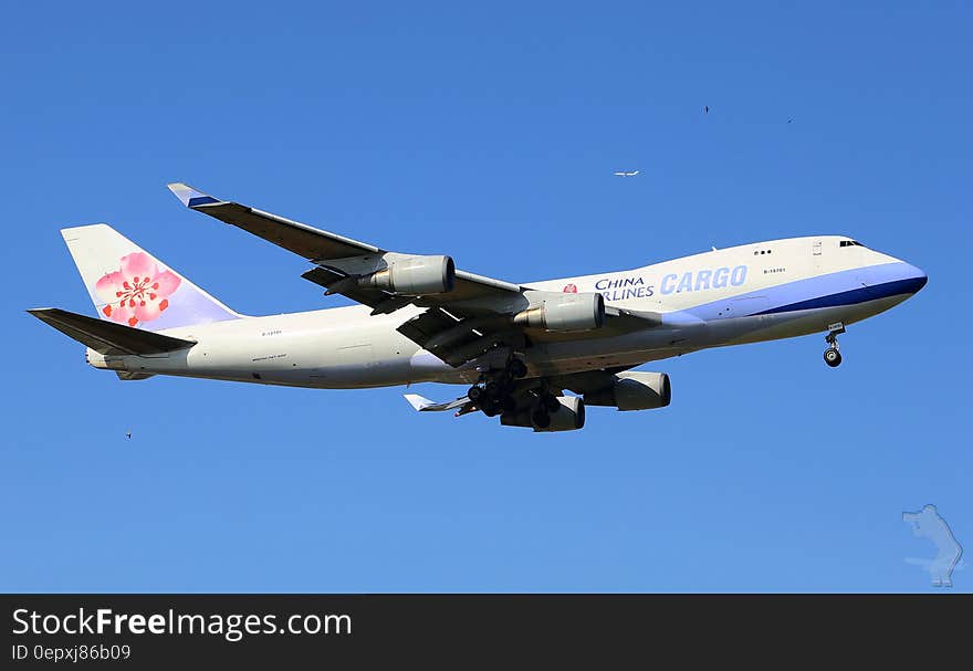 China Airlines cargo plane flying in blue skies.