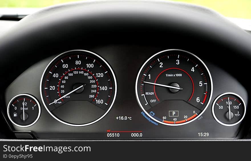 Dials and gauges on leather dashboard of luxury car. Dials and gauges on leather dashboard of luxury car.