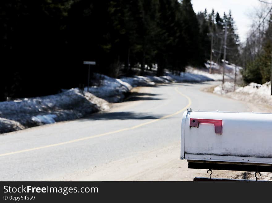 White Metal Mailbox Near Grey Asphalt Road at Day Time