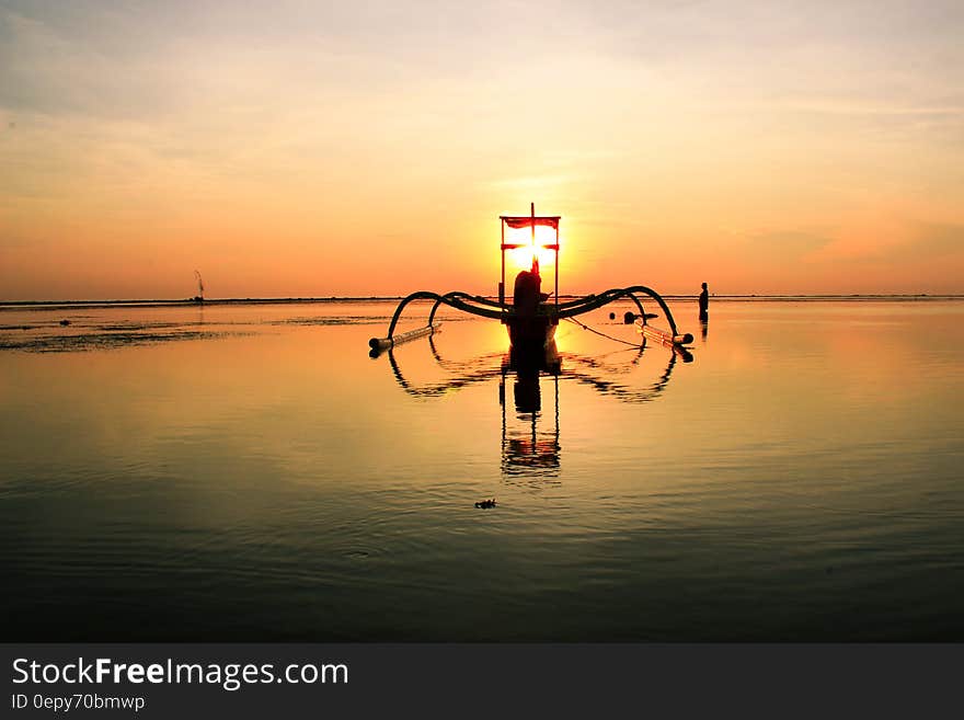 Sailboat on Clear Calm Sea Floating during Sunset