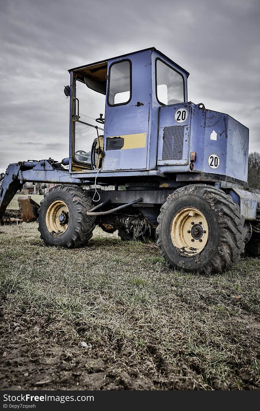 Blue and Black Tractor in Green Grass