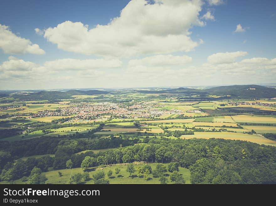 Aerial Photography of Green Fields Under Blue Sky and White Clouds during Daytime