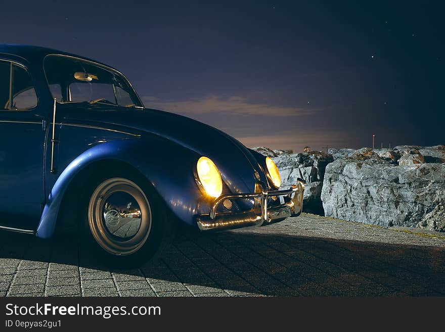 Blue Volkswagen Beetle Car Near Cliff during Night Time