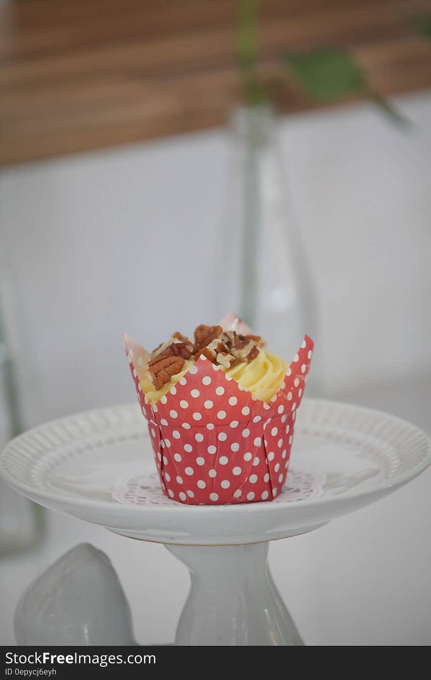 Yellow and Brown Cupcake on White Round Ceramic Plate