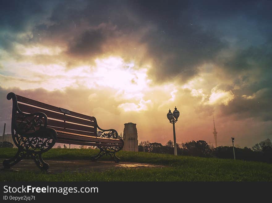 Black Steel Frame Brown Wooden Bench during Daytime