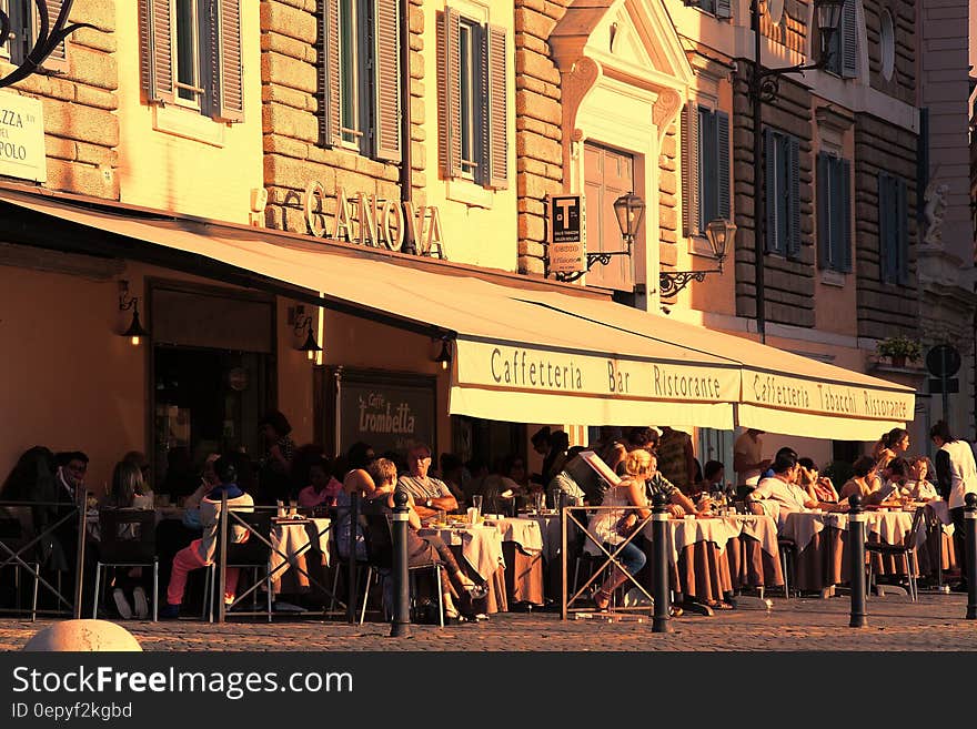 People Sitting Outside Caffetteria during Daytime