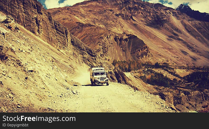 White Truck Riding on Brown Sandy Surface during Daytime