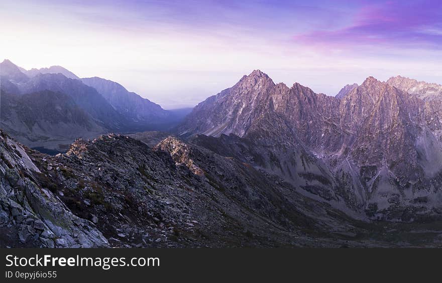 Brown Black and White Mountain Under White and Blue Cloudy Sky