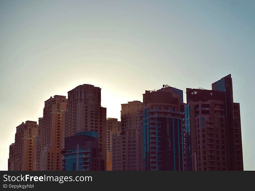 Brown City Skyline Under White and Gray Clear Sky during Daytime