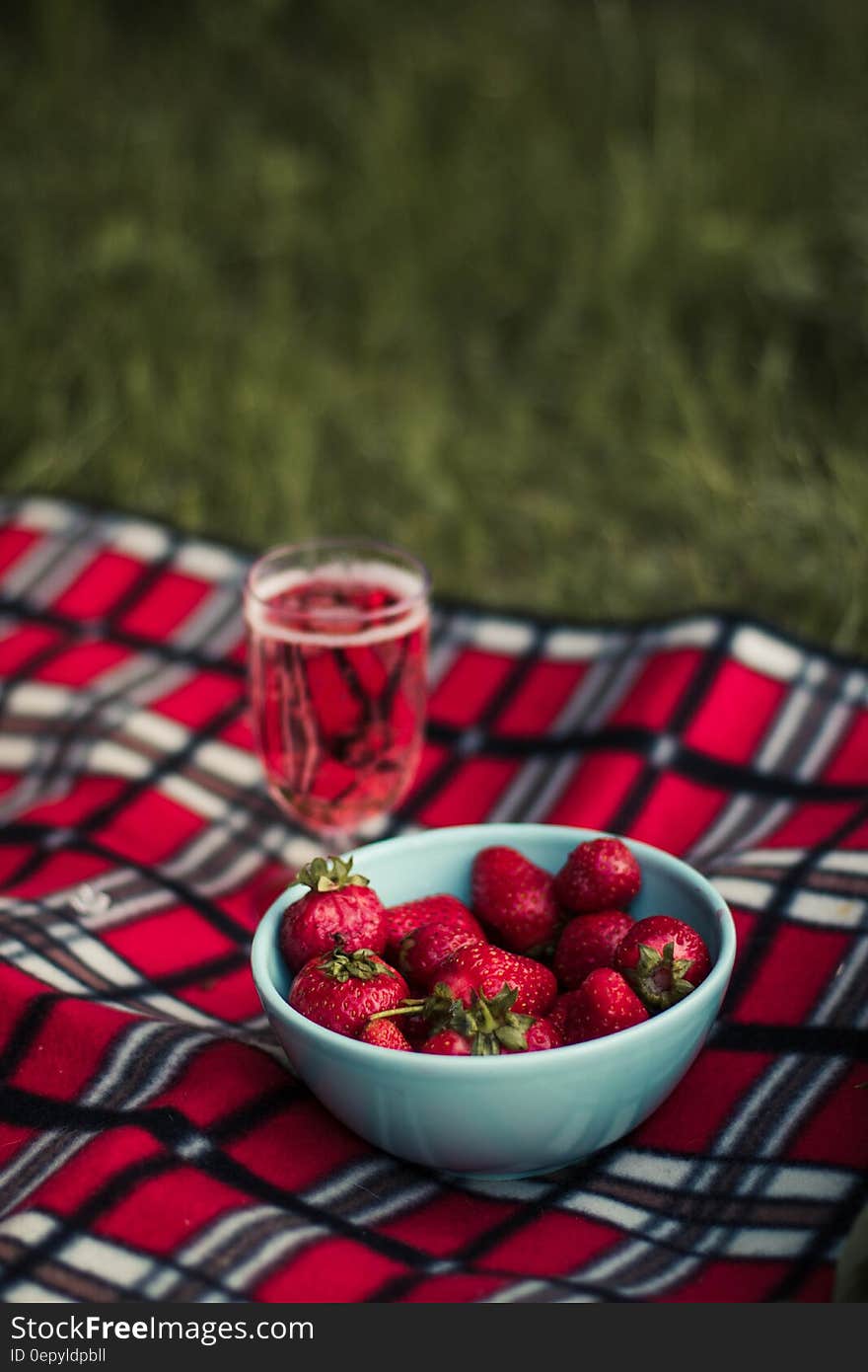 Strawberry on White Ceramic Round Bowl on Pink White and Brown Plaid Textile